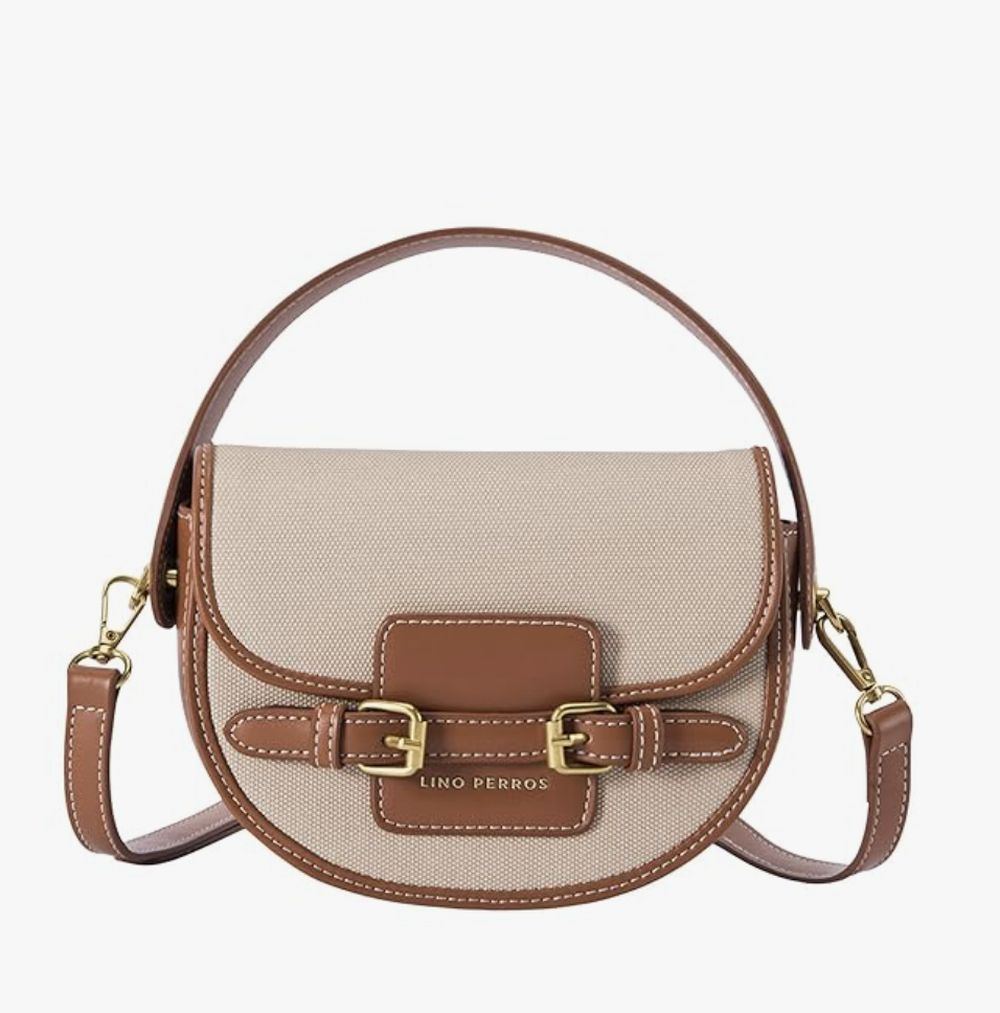 A tan and cream leather saddle bag squared up on white for a catalogue.