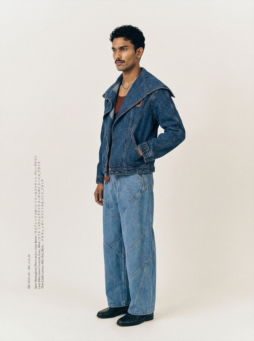 Full-length denim jacket and jeans against a pale studio wall.